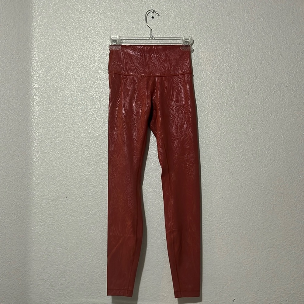 Lululemon leggings. Pink with a subtle pattern, size 4, great condition.